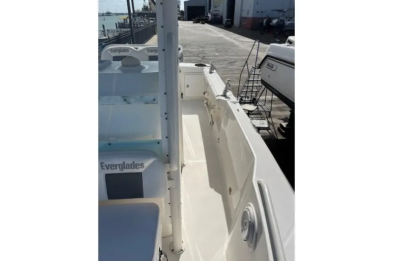 Slide: The Image of 2007 Everglades 240 Center Console boat docked, showcasing spacious deck and seating. - 11