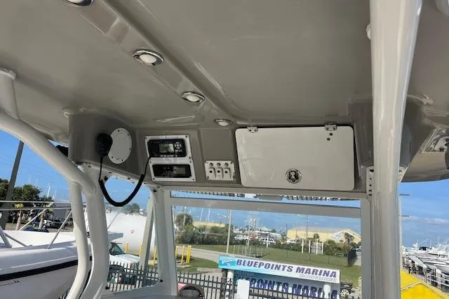 Slide: The Image of 2007 Everglades 240 Center Console boat interior with control panel and storage compartment. - 12