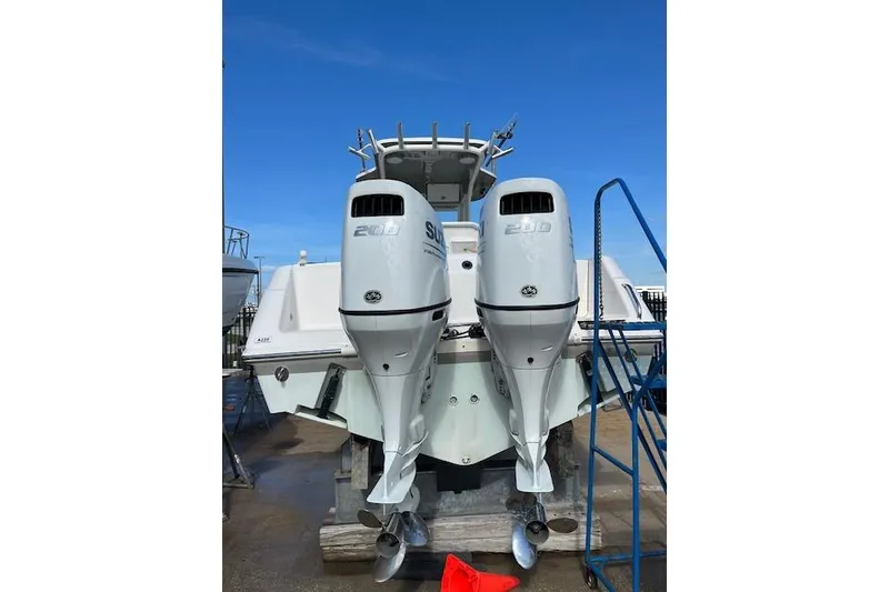 Slide: The Image of 2007 Everglades 240 Center Console boat with twin outboard engines, docked under clear skies. - 14