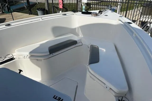 Slide: The Image of 2007 Everglades 240 Center Console boat interior with cushioned seating and storage compartments. - 3