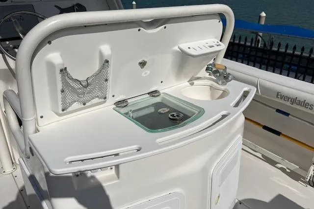 Slide: The Image of 2007 Everglades 240 Center Console boat interior with sink and storage compartments. - 8