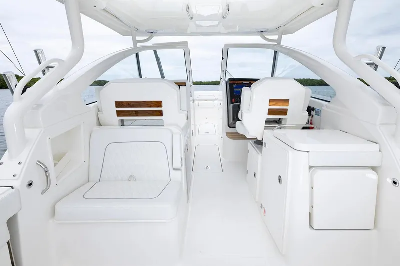 Slide: The Image of Manufacturer Provided Image: 2026 Pursuit DC 286 Dual Console boat interior with white seating and modern design. - 10