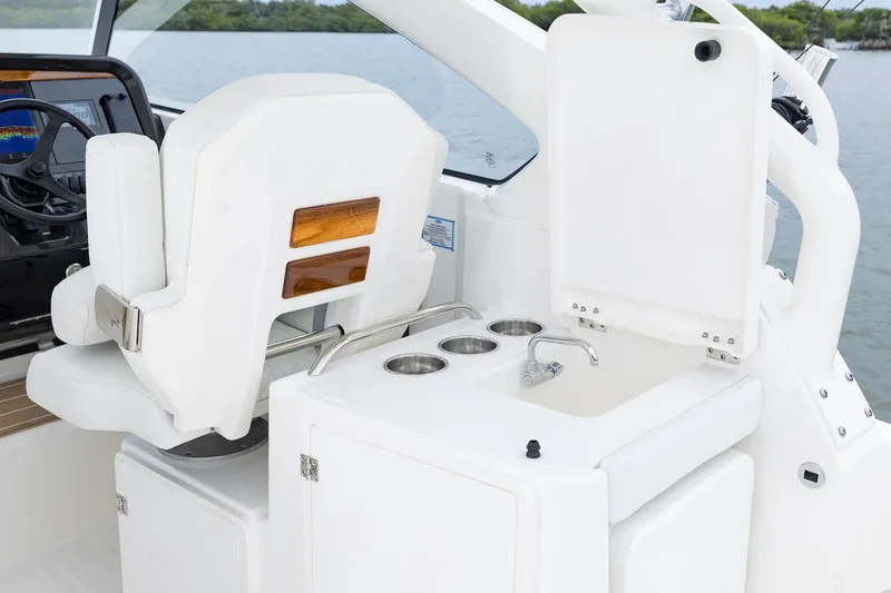 Slide: The Image of Manufacturer Provided Image: 2026 Pursuit DC 286 Dual Console boat interior with helm seat and sink area. - 11