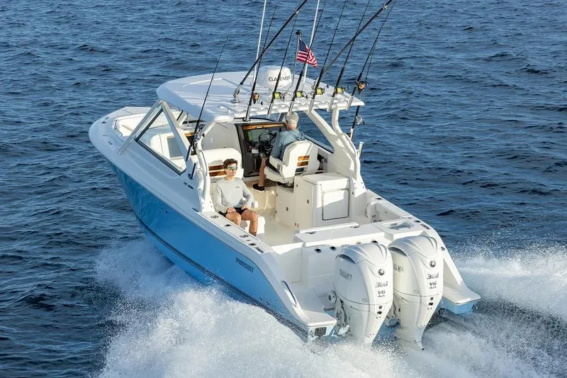 Slide: The Image of Manufacturer Provided Image: 2026 Pursuit DC 286 Dual Console boat cruising on open water with fishing rods. - 2