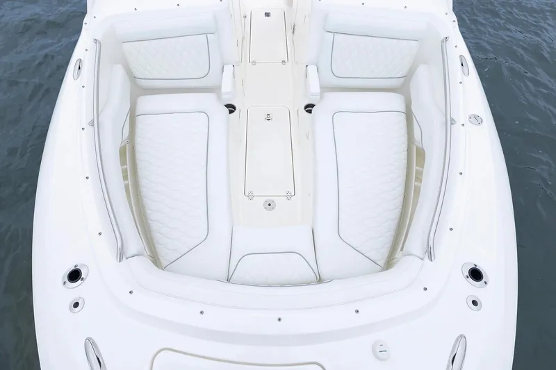 Slide: The Image of Manufacturer Provided Image: 2026 Pursuit DC 286 Dual Console boat with white cushioned seating on water. - 3