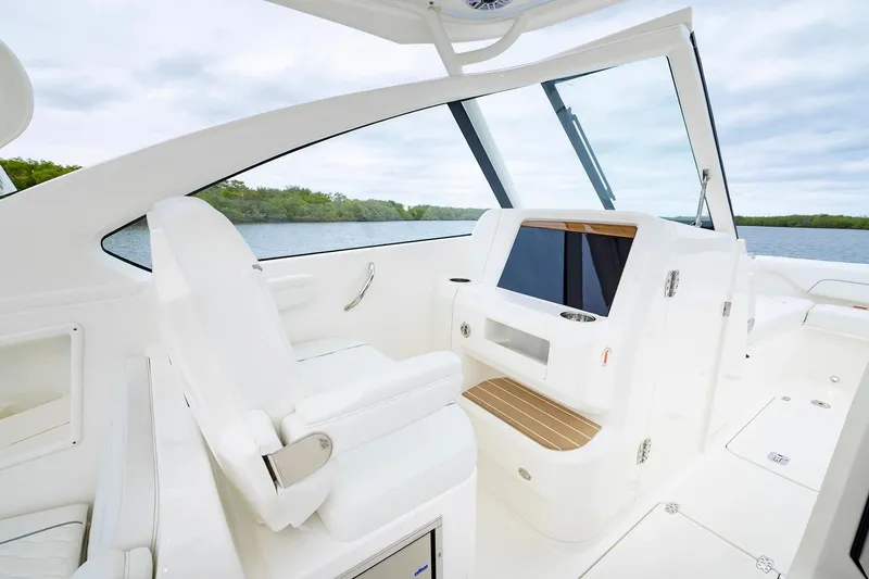 Slide: The Image of Manufacturer Provided Image: 2026 Pursuit DC 286 Dual Console boat interior with sleek white seating and modern design. - 7