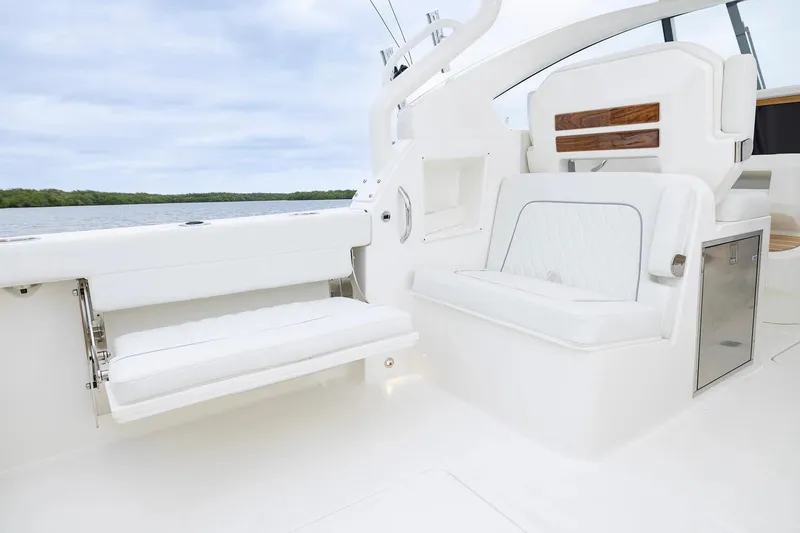 Slide: The Image of Manufacturer Provided Image: 2026 Pursuit DC 286 Dual Console boat interior with white seating and storage. - 8