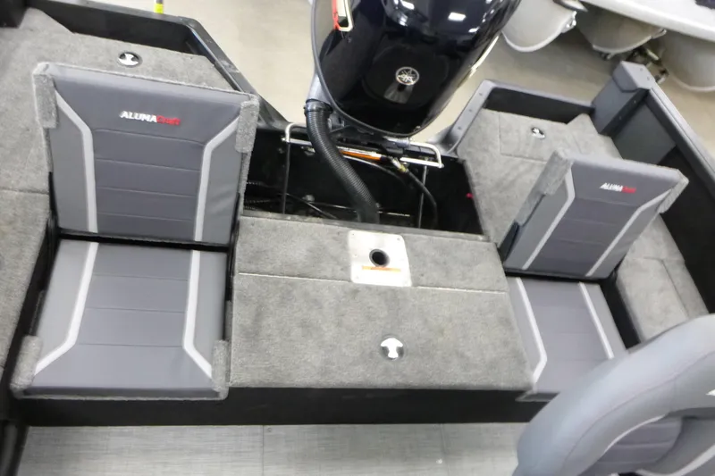 Slide: The Image of 2024 Alumacraft Competitor FSX 175 boat interior with gray seating and motor. - 12