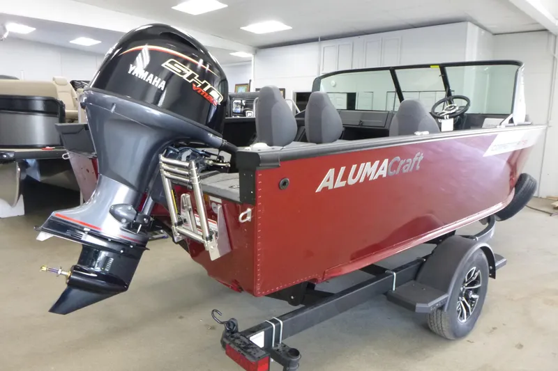 Slide: The Image of 2024 Alumacraft Competitor FSX 175 boat with Yamaha engine, displayed indoors on a trailer. - 2