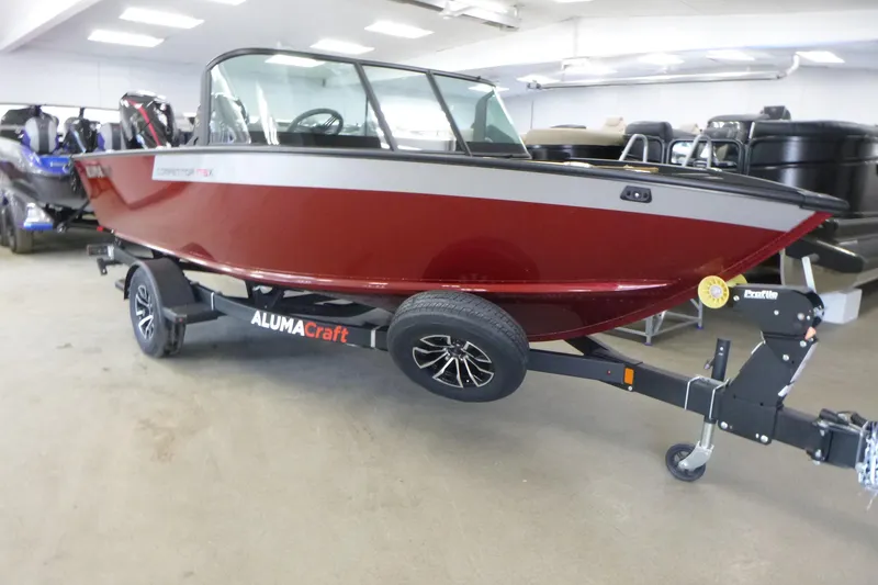Slide: The Image of 2024 Alumacraft Competitor FSX 175 boat in showroom, red exterior, on trailer. - 3