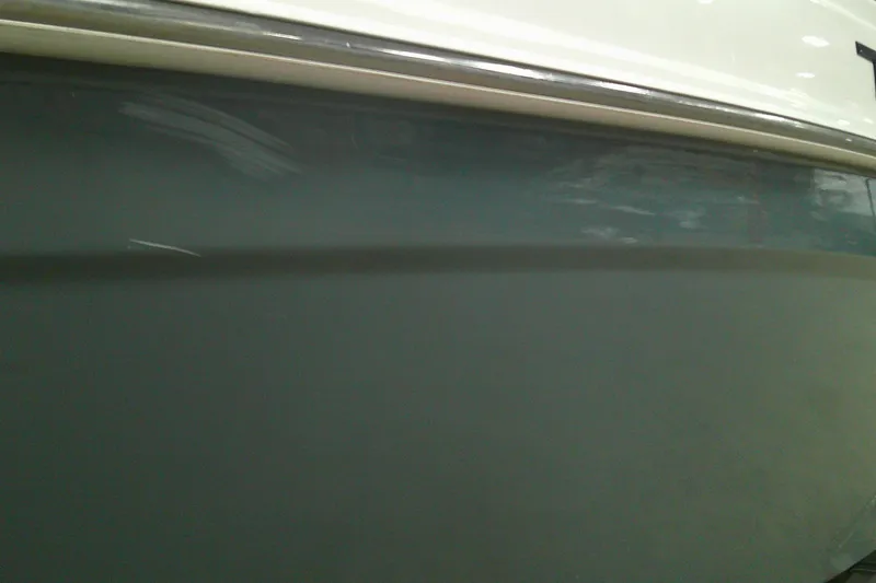 Slide: The Image of Close-up of 2023 Tahoe T21 boat hull, showcasing sleek design and smooth finish. - 13