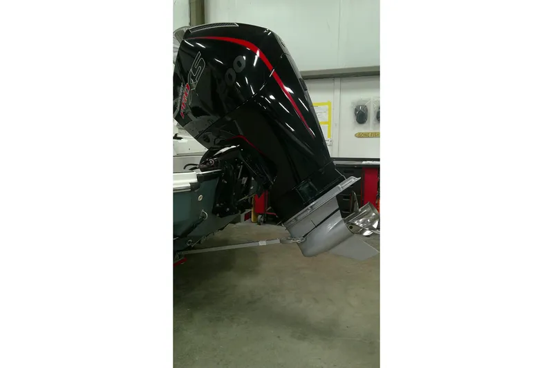 Slide: The Image of 2023 Tahoe T21 boat with powerful outboard motor in a garage setting. - 14