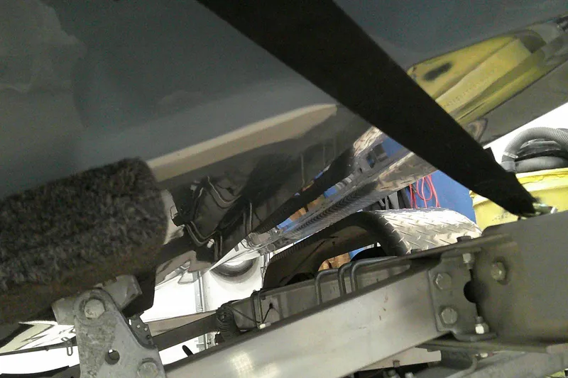 Slide: The Image of Undercarriage view of 2023 Tahoe T21 boat on trailer in garage. - 17