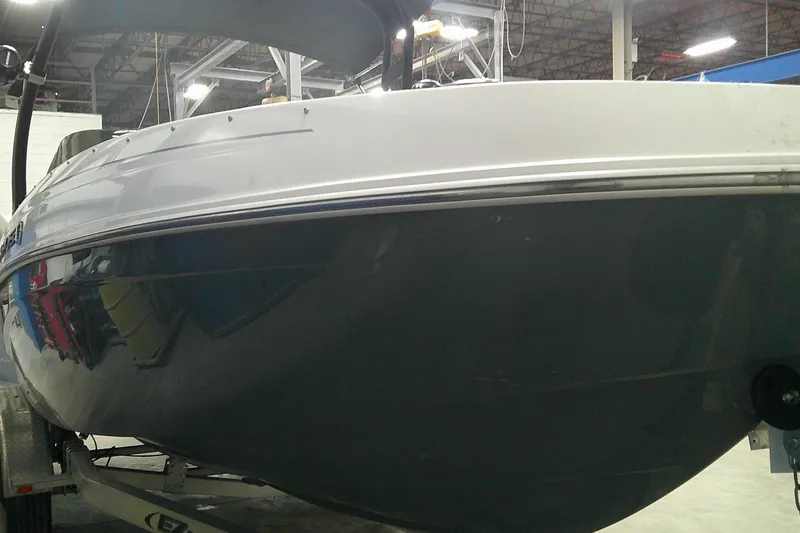 Slide: The Image of 2023 Tahoe T21 boat in a warehouse, showcasing sleek design and modern features. - 2