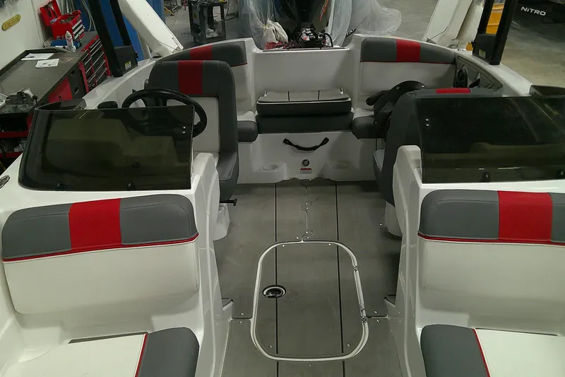 Slide: The Image of 2023 Tahoe T21 boat interior with red and gray seating, dual steering wheels. - 5