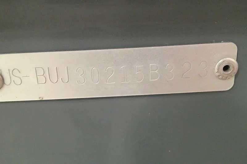 Slide: The Image of Metallic identification plate with engraved code "US-BUJ30215B323" on Tahoe T21, 2023 model. - 8