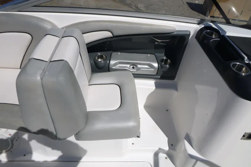 Slide: The Image of 2011 Yamaha AR240 HO boat interior with gray and white seating and cup holders. - 10