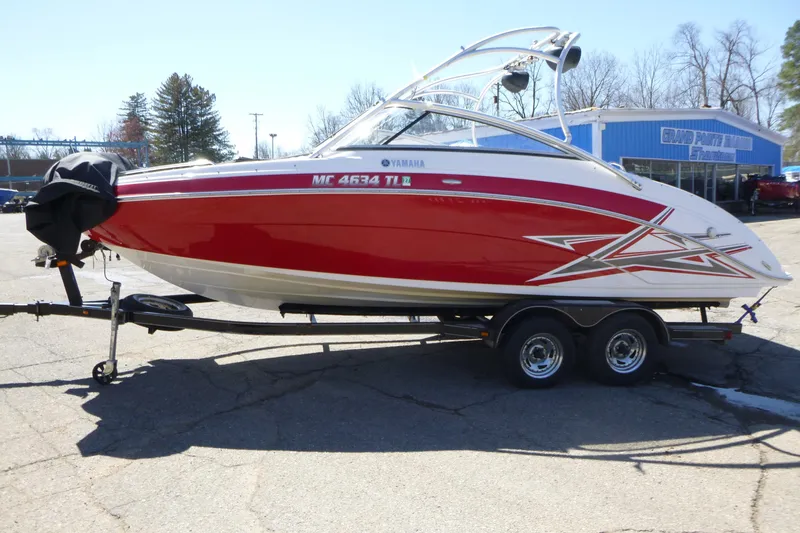 Slide: The Image of 2011 Yamaha Boats AR240 HO in red on trailer, parked outdoors. - 3
