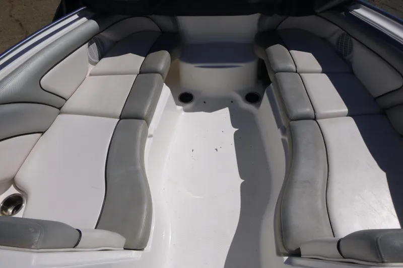Slide: The Image of Interior seating of a 2011 Yamaha Boats AR240 HO, featuring gray and white upholstery. - 6
