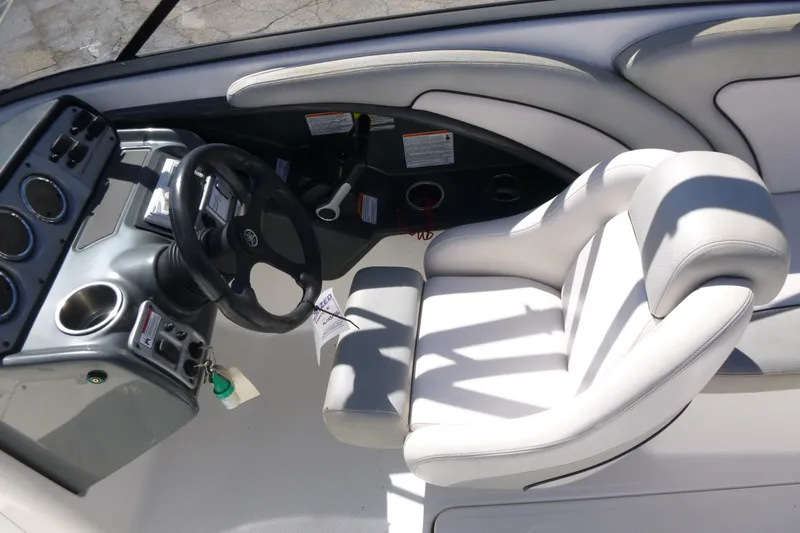 Slide: The Image of 2011 Yamaha Boats AR240 HO cockpit with steering wheel and white captain's chair. - 7