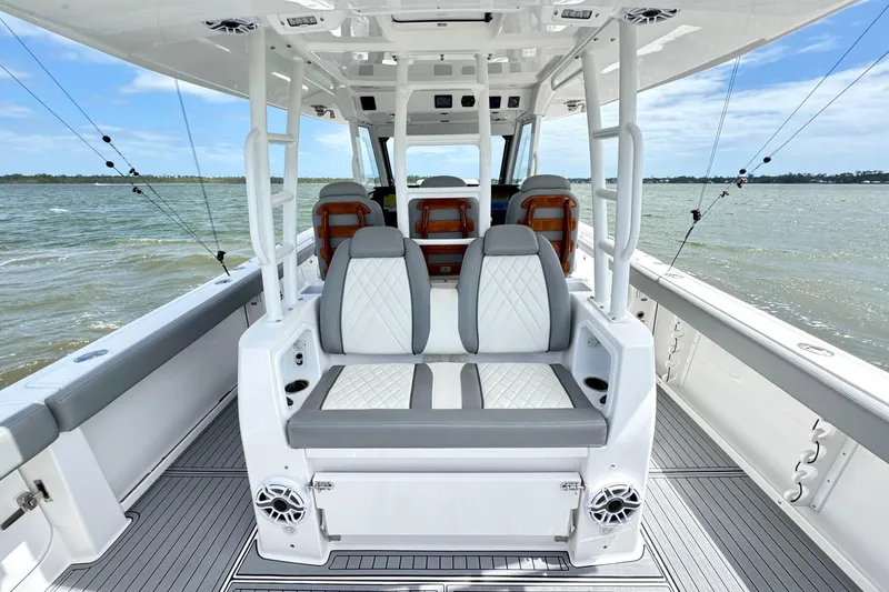 Slide: The Image of 2023 Everglades 395 Center Console boat interior with luxurious seating on open water. - 11