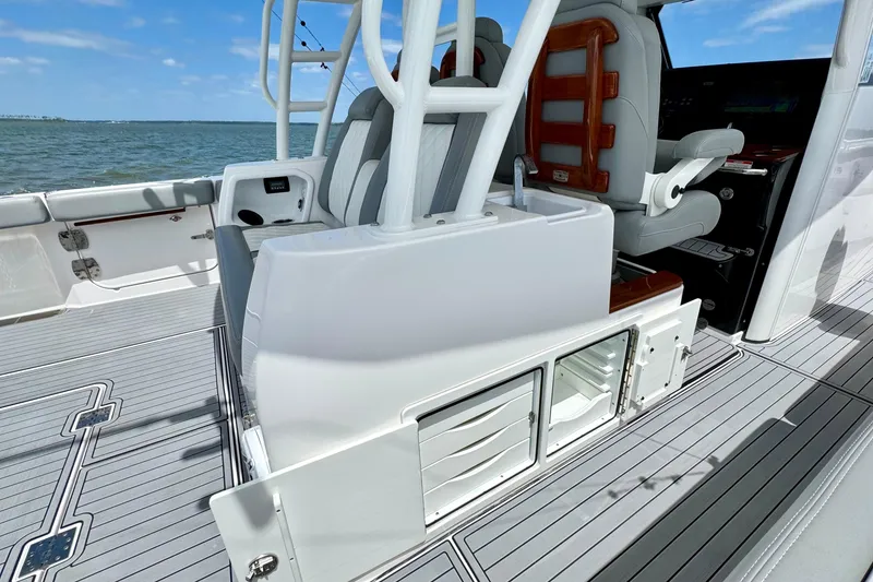 Slide: The Image of 2023 Everglades 395 Center Console boat interior with seating and storage, on open water. - 18