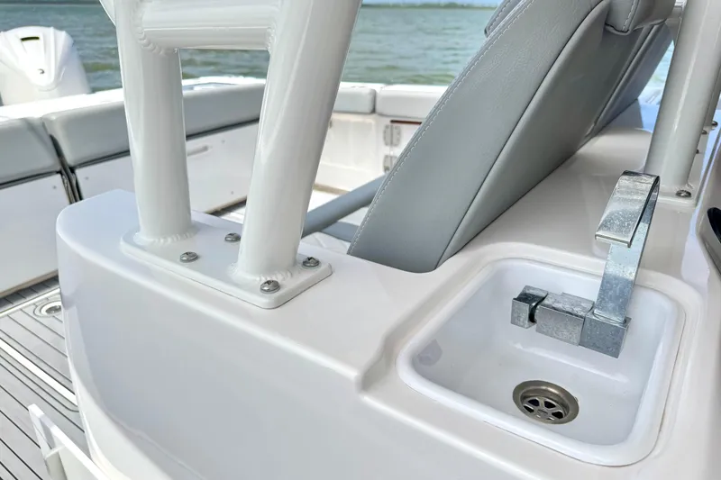 Slide: The Image of 2023 Everglades 395 Center Console boat interior with seating and sink detail. - 21