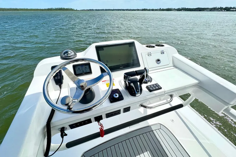 Slide: The Image of Helm of 2023 Everglades 395 Center Console boat with modern controls and navigation system. - 24