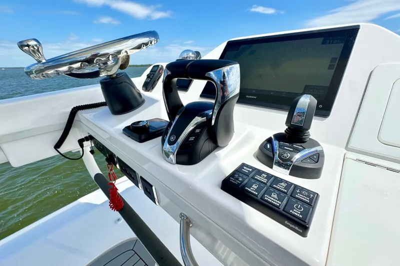 Slide: The Image of Control panel of 2023 Everglades 395 Center Console boat with steering wheel and navigation system. - 25