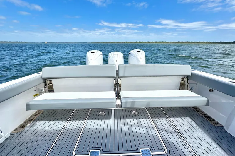 Slide: The Image of 2023 Everglades 395 Center Console boat with seating, ocean view, and triple engines. - 29