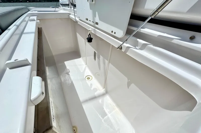 Slide: The Image of Open storage compartment on 2023 Everglades 395 Center Console boat. - 32