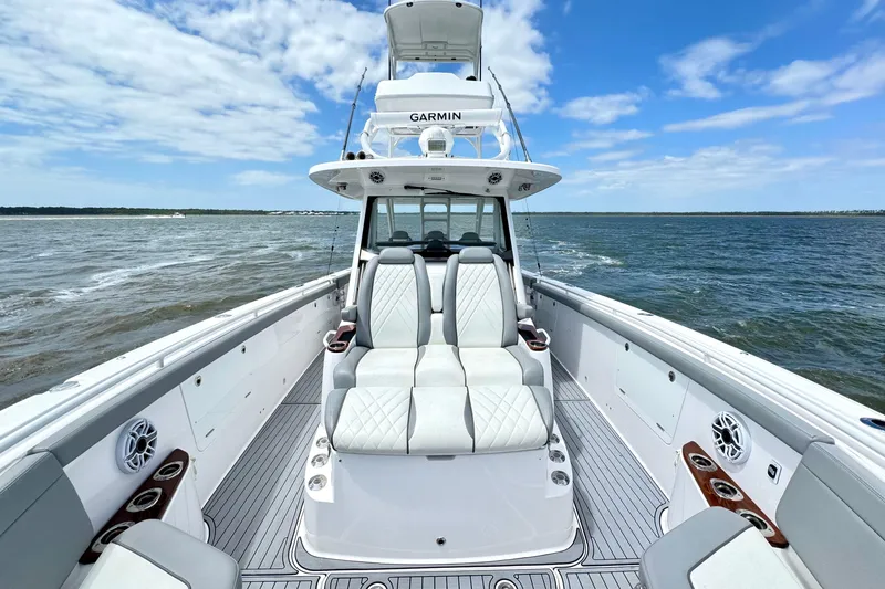 Slide: The Image of 2023 Everglades 395 Center Console boat on open water, featuring luxurious seating and modern design. - 33