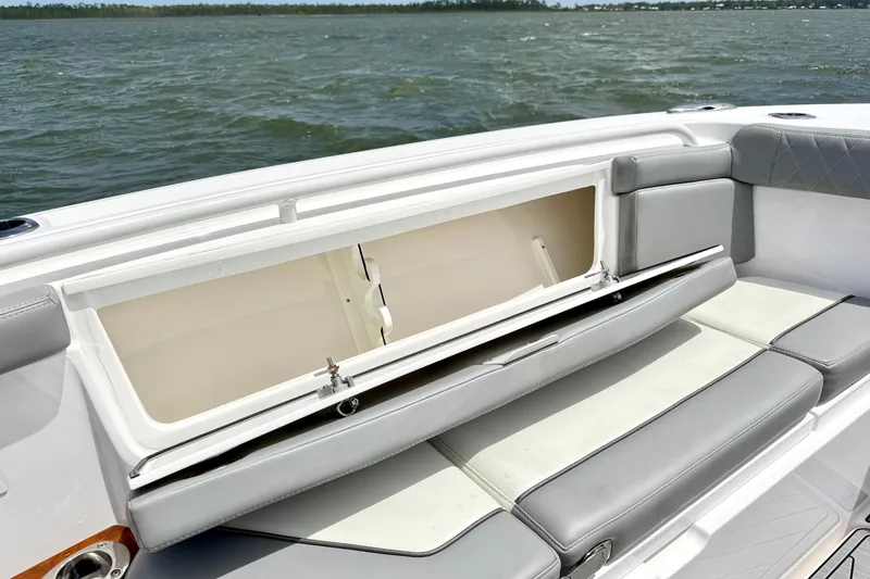 Slide: The Image of 2023 Everglades 395 Center Console boat with open storage compartment on deck. - 38