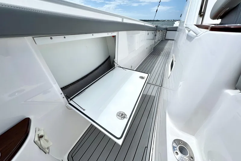 Slide: The Image of 2023 Everglades 395 Center Console boat with open storage compartment and sleek deck design. - 39