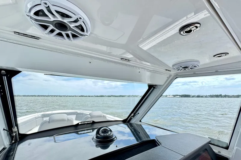 Slide: The Image of Interior view of 2023 Everglades 395 Center Console boat with water in the background. - 44
