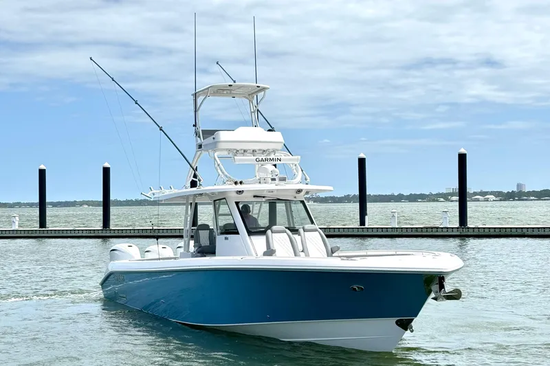 Slide: The Image of 2023 Everglades 395 Center Console boat on water, featuring sleek design and advanced navigation. - 5