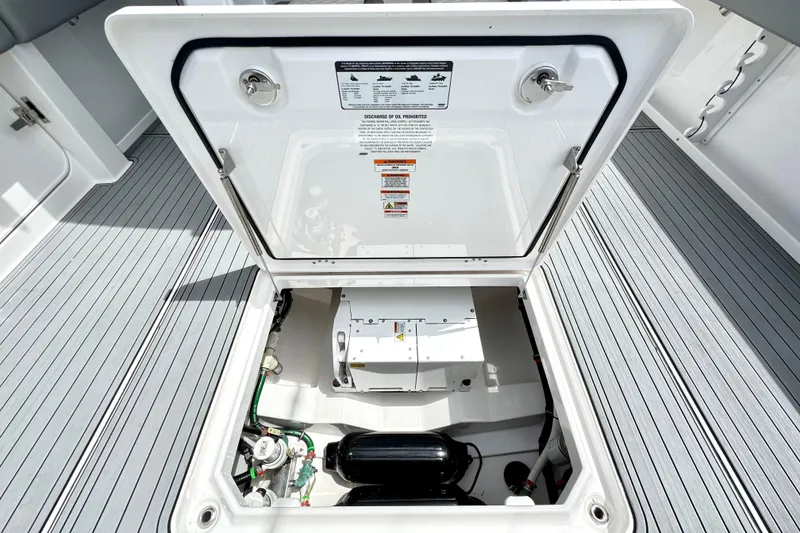 Slide: The Image of Open hatch of 2023 Everglades 395 Center Console boat, revealing internal components. - 51