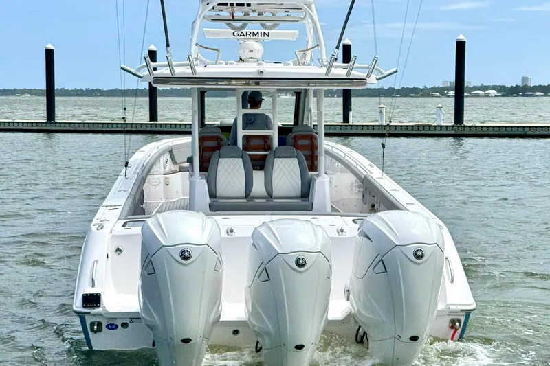 Slide: The Image of 2023 Everglades 395 Center Console boat with triple engines on the water. - 6