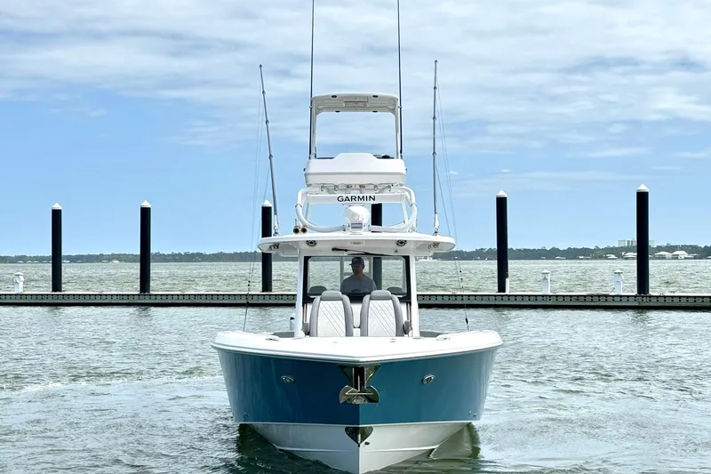 Slide: The Image of 2023 Everglades 395 Center Console boat docked on a calm, scenic waterfront. - 7