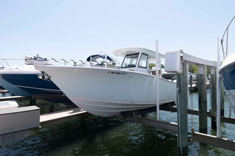 The Image of 2022 Sportsman Open 282 Center Console boat docked at marina. - 0