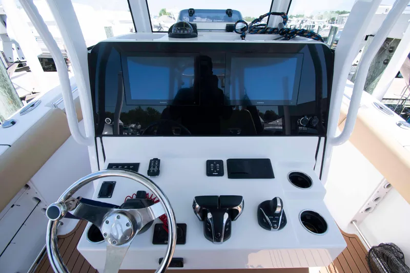 Slide: The Image of 2022 Sportsman Open 282 Center Console helm with dual screens and modern controls. - 10