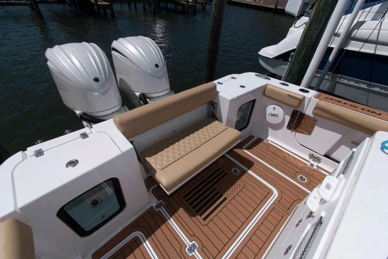 Slide: The Image of 2022 Sportsman Open 282 Center Console boat with dual engines and cushioned seating. - 11