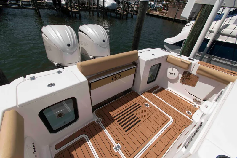 Slide: The Image of 2022 Sportsman Open 282 Center Console boat with dual engines and teak-style deck. - 12