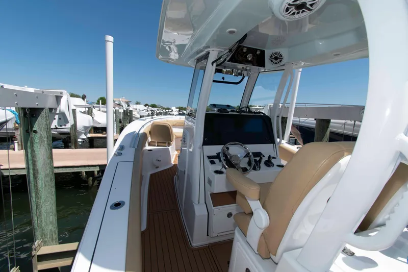 Slide: The Image of 2022 Sportsman Open 282 Center Console boat docked, featuring sleek design and modern controls. - 13