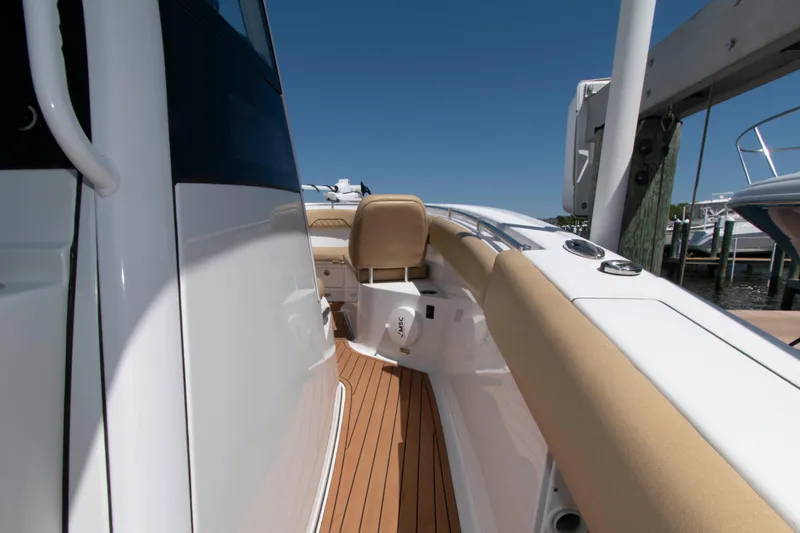 Slide: The Image of 2022 Sportsman Open 282 Center Console boat with tan seating and sleek design. - 14