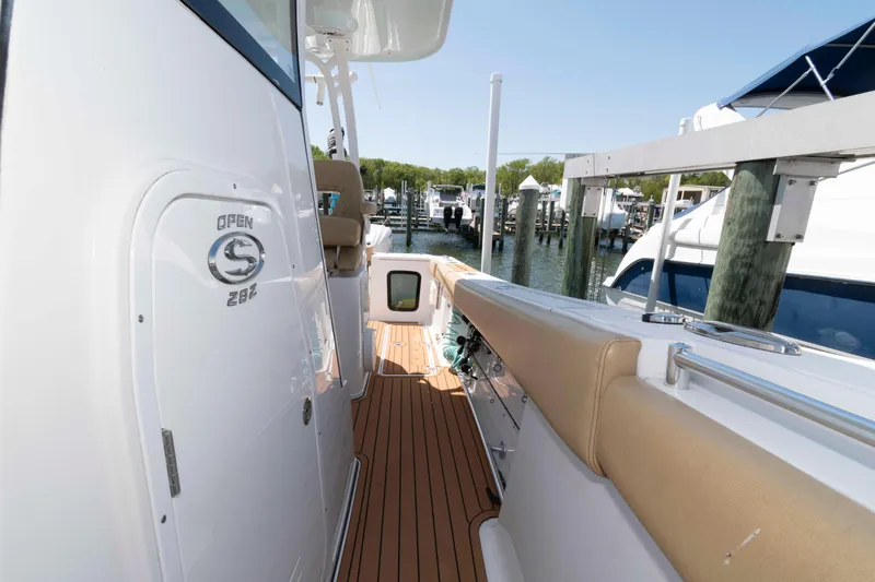Slide: The Image of 2022 Sportsman Open 282 Center Console boat docked, featuring sleek design and spacious deck. - 15