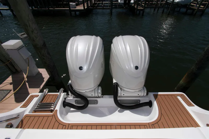 Slide: The Image of 2022 Sportsman Open 282 Center Console with dual outboard engines at dock. - 18