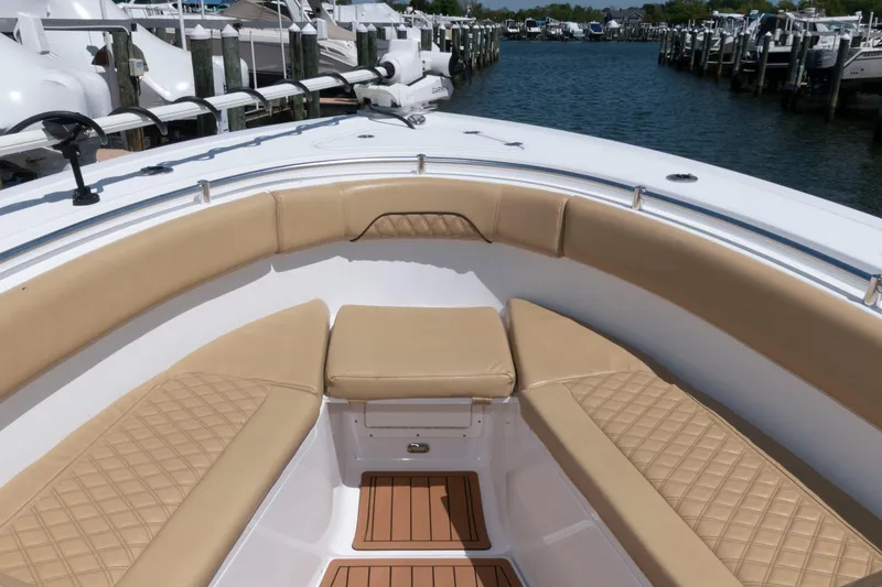 Slide: The Image of 2022 Sportsman Open 282 Center Console boat with tan seating, docked at marina. - 6