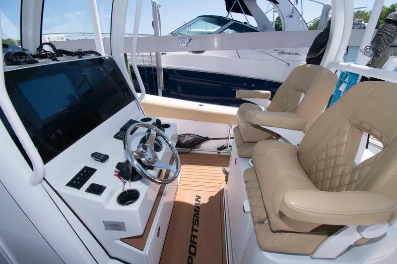 Slide: The Image of 2022 Sportsman Open 282 Center Console interior with dual seats and modern helm controls. - 8