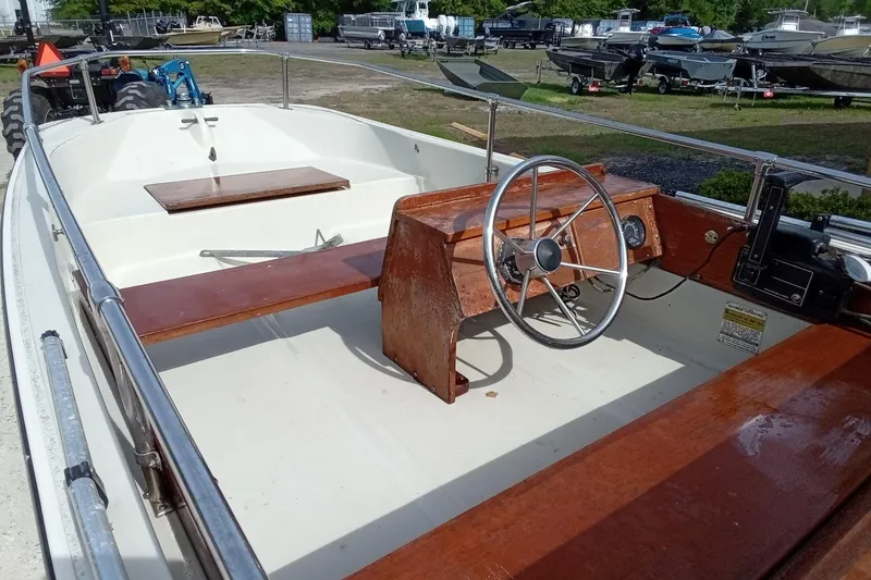 Slide: The Image of 1985 Boston Whaler 13 Sport boat interior with wooden console and steering wheel. - 12